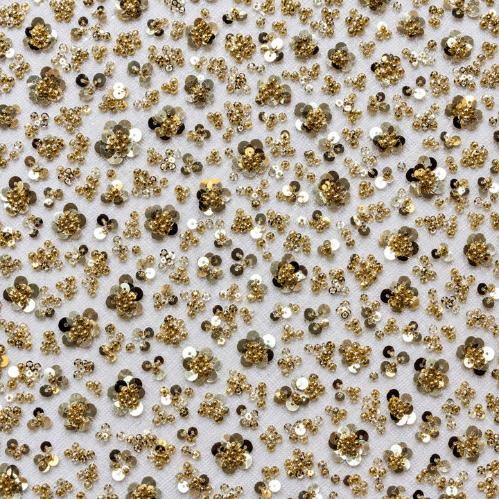 Square detail of gold layered sequin blossoms and beaded vines on sheer white tulle