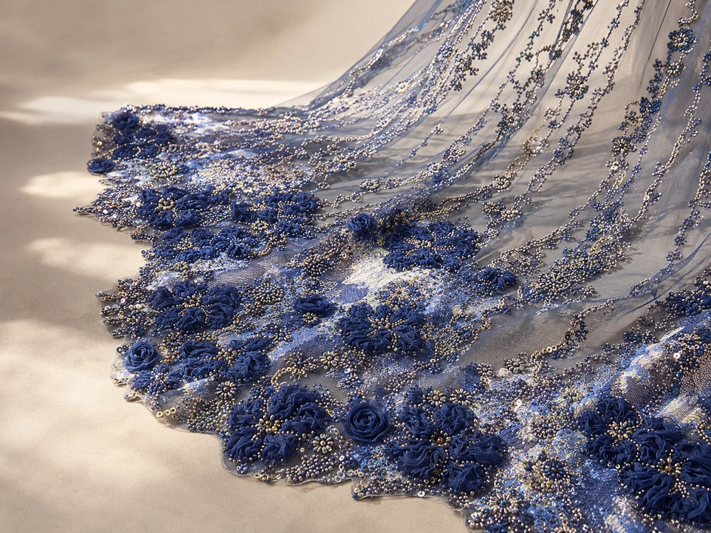 Blue floral beaded tulle draped on a light surface