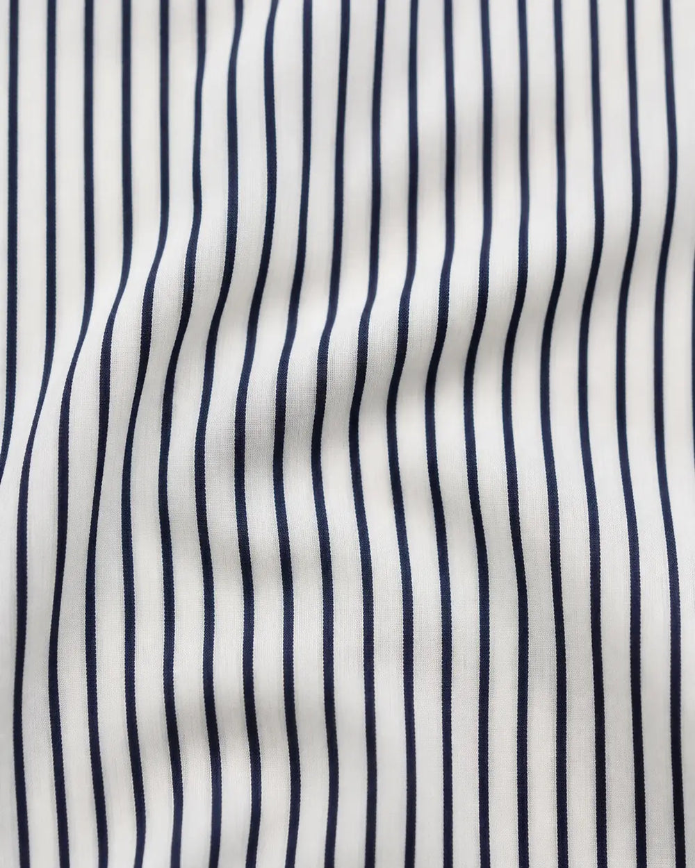 White cotton fabric with fine navy pinstripes