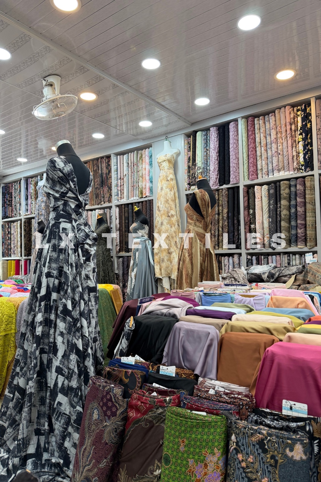 Mannequins and colourful fabric displays inside an LX Textiles retail store